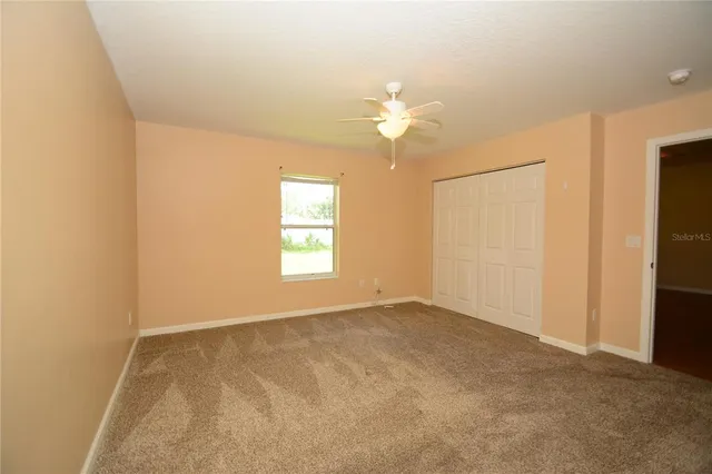 an empty room with windows and closet