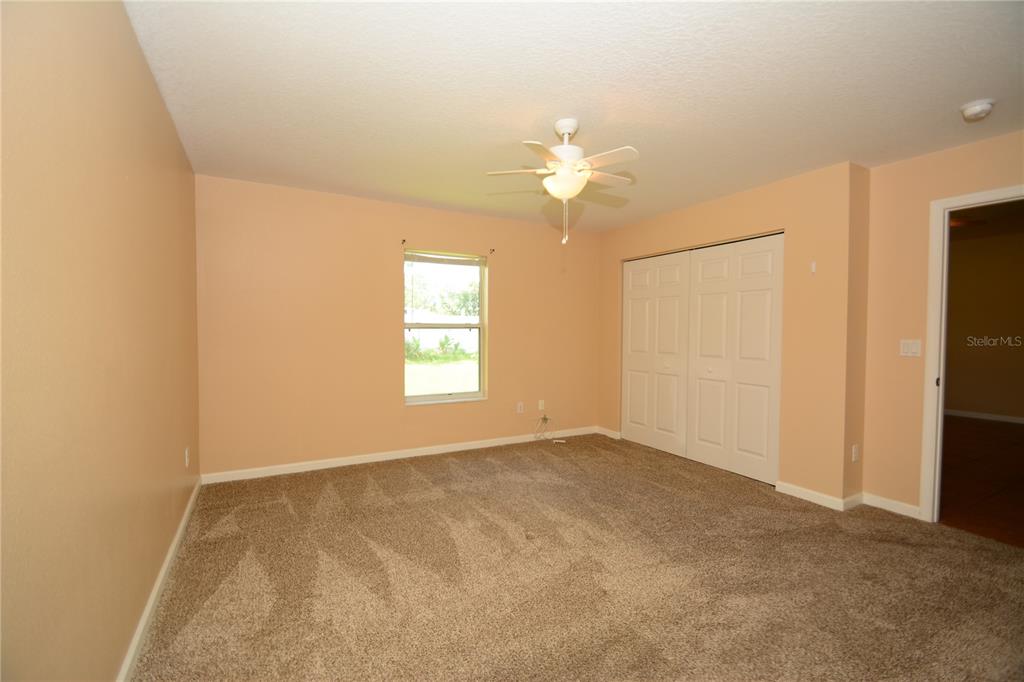 37 Eton Lane, Unit A Palm Coast, FL 32164 - Photo 22 of 34 an empty room with windows and closet