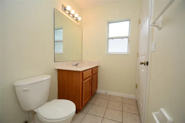 a bathroom with a sink a toilet and mirror