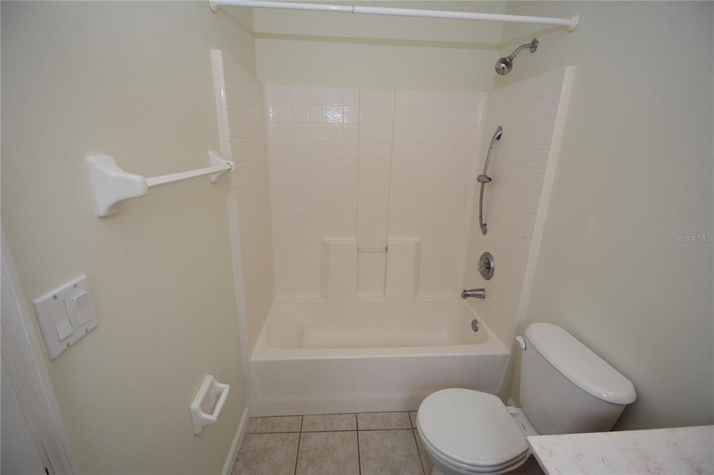 37 Eton Lane, Unit A Palm Coast, FL 32164 - Photo 25 of 34 a bathroom with a toilet and a shower