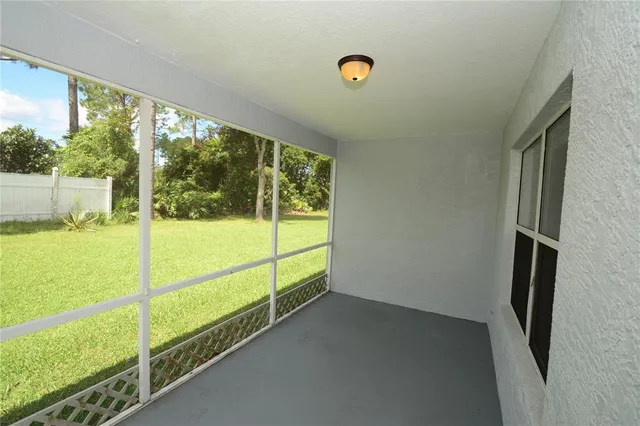 a view of a porch with a floor to ceiling window