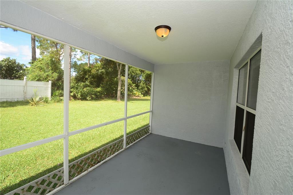37 Eton Lane, Unit A Palm Coast, FL 32164 - Photo 28 of 34 a view of a porch with a floor to ceiling window