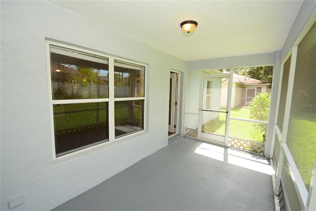 37 Eton Lane, Unit A Palm Coast, FL 32164 - Photo 29 of 34 an empty room with sliding glass door and windows