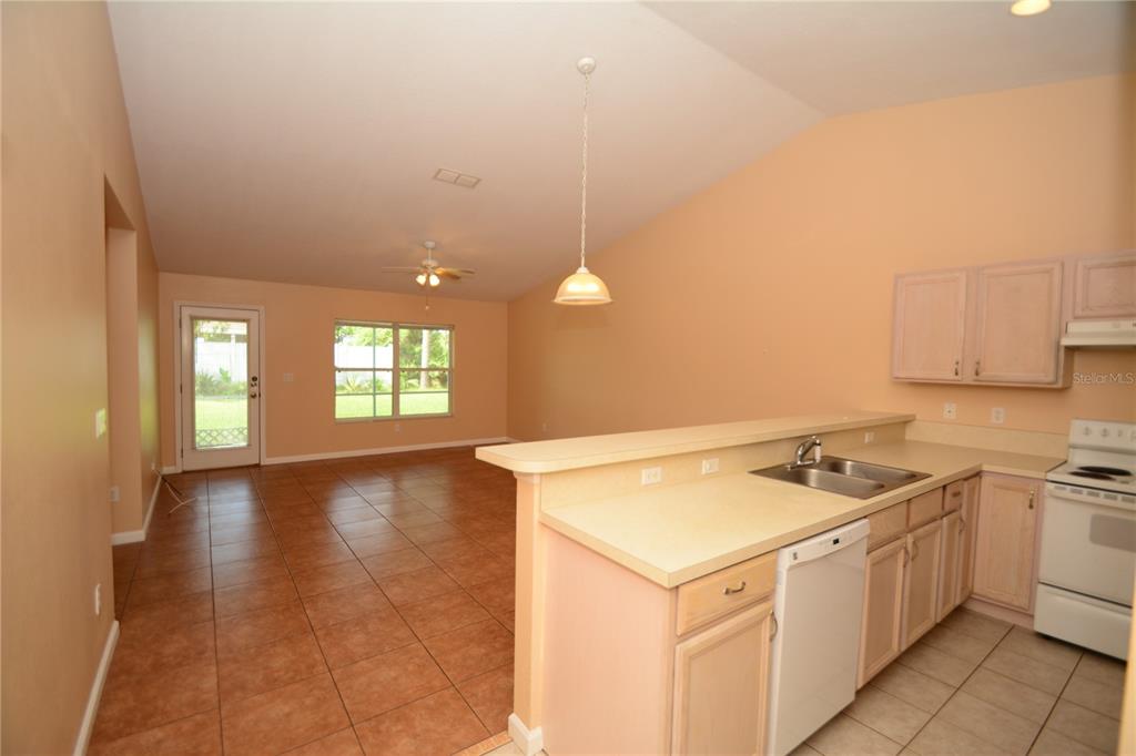 37 Eton Lane, Unit A Palm Coast, FL 32164 - Photo 9 of 34 a kitchen that has a sink a stove and window