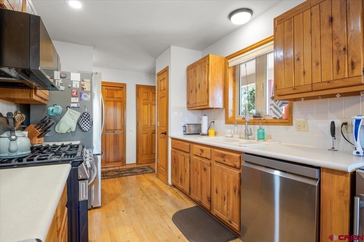 19016 Pinon Drive Cedaredge, CO 81413 - Photo 18 of 45 a kitchen with stainless steel appliances granite countertop a sink stove and refrigerator