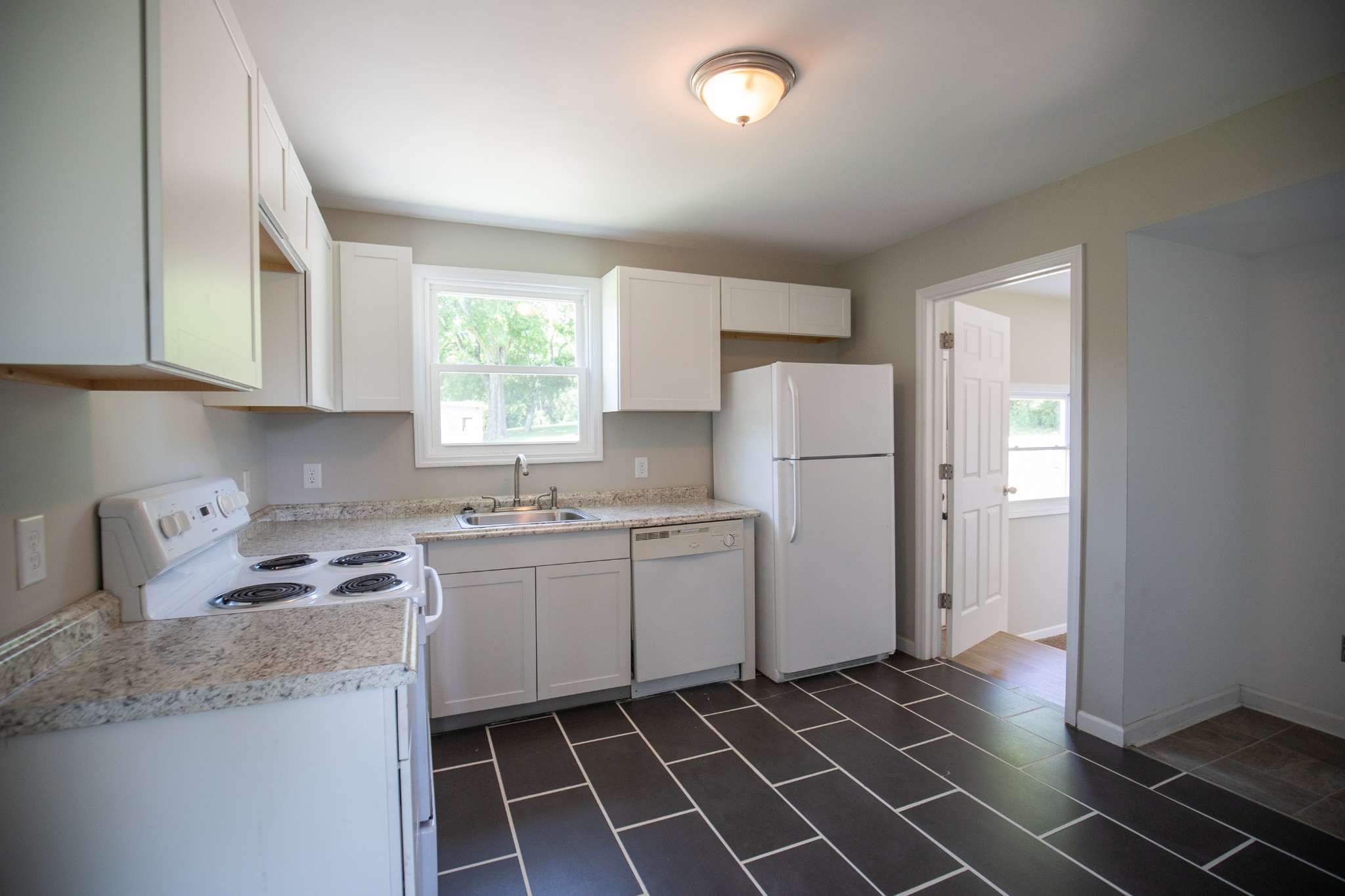 Undisclosed Address Madison, TN 37115 - Photo 13 of 17 a kitchen with a sink a refrigerator and cabinets