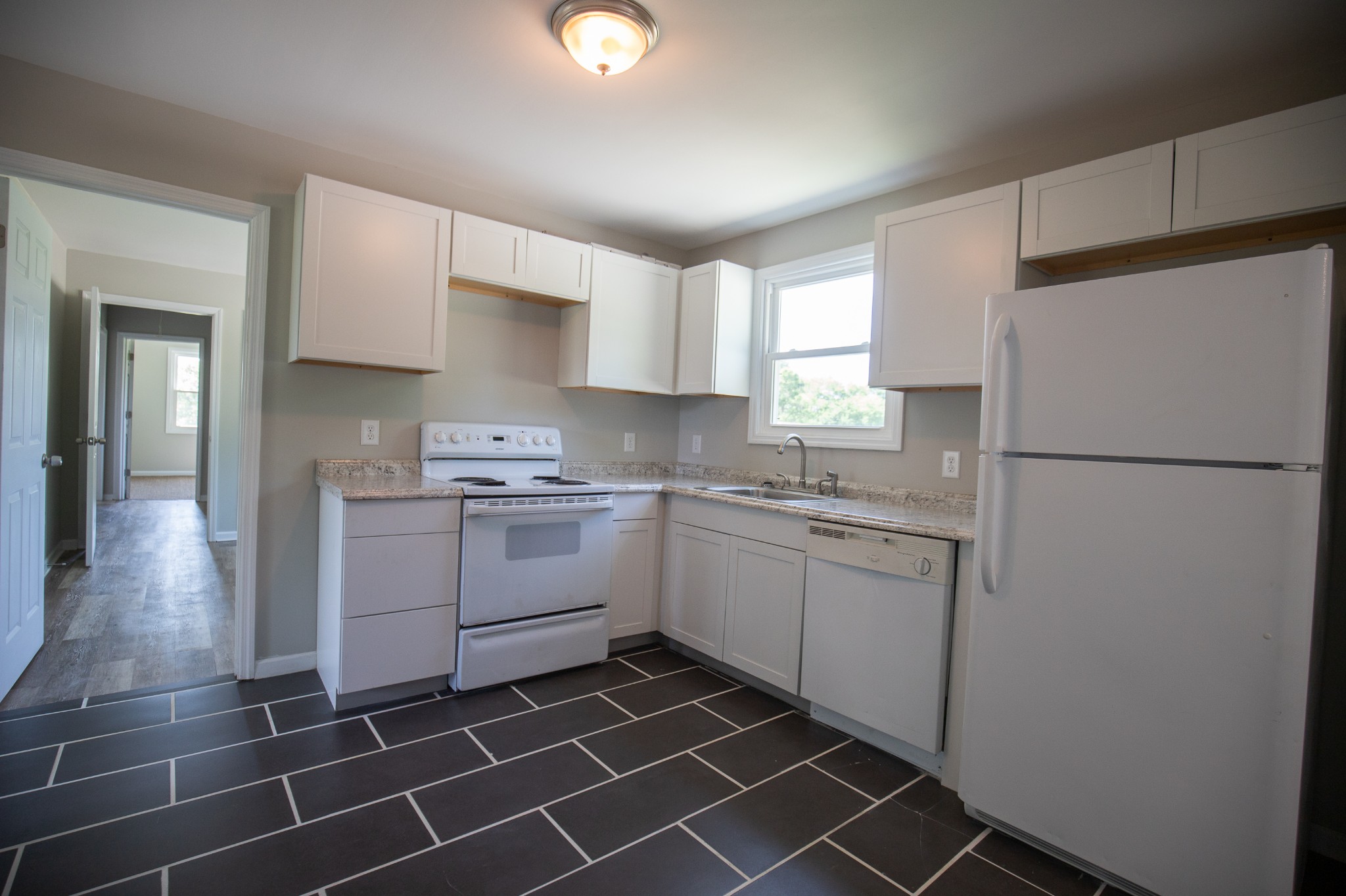 Undisclosed Address Madison, TN 37115 - Photo 3 of 17 a kitchen with a sink a refrigerator and cabinets
