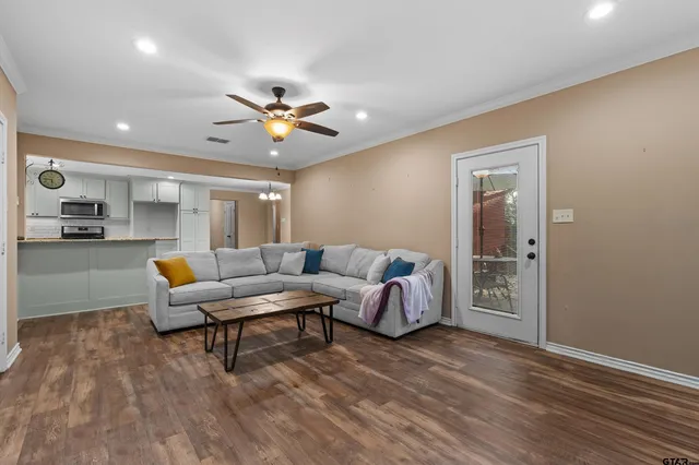 a living room with furniture and a chandelier