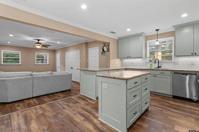 a kitchen with granite countertop white cabinets and white appliances