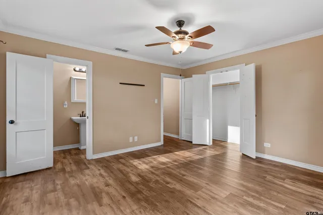 a view of a livingroom with a ceiling fan window and wooden floor