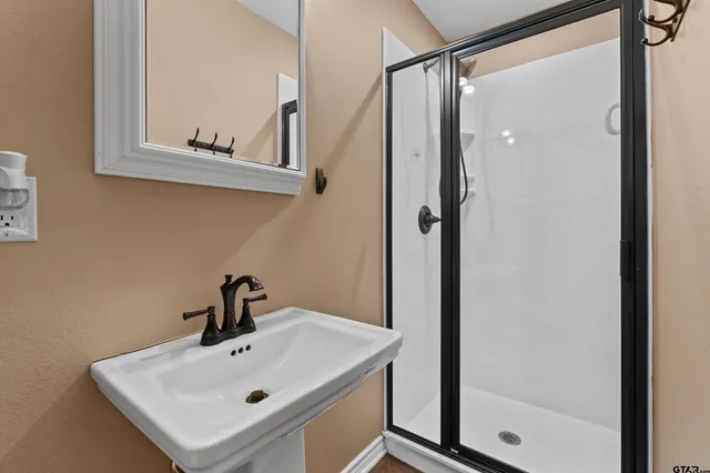 a bathroom with a sink and mirror