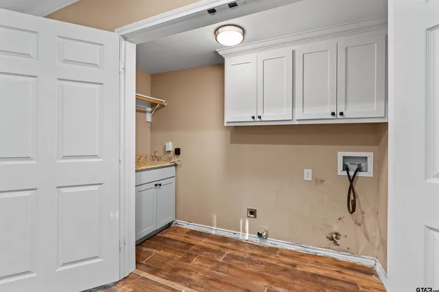 a view of walk in closet with hardwood floor
