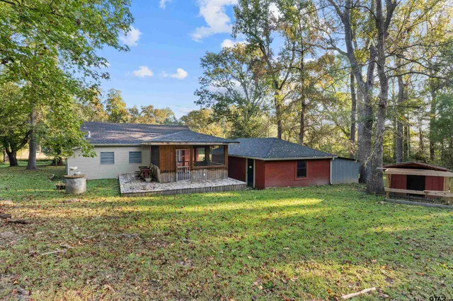 a view of a house with a yard porch and sitting area