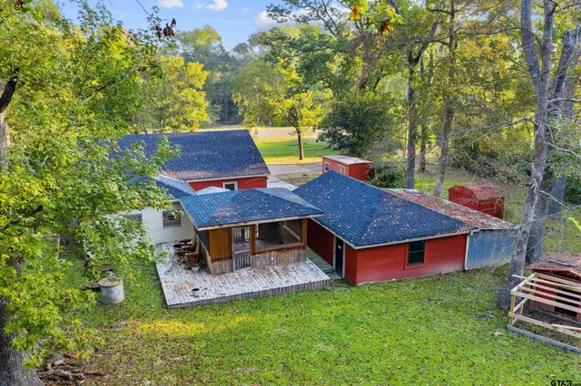an aerial view of a house with a yard