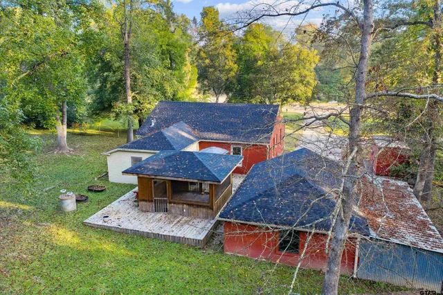 an aerial view of a house with a yard table and chairs
