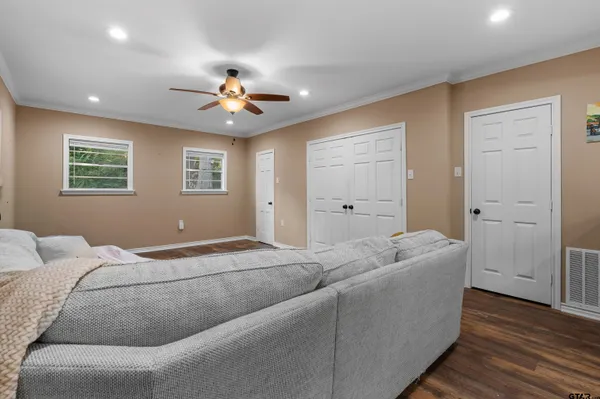 a living room with furniture and a ceiling fan