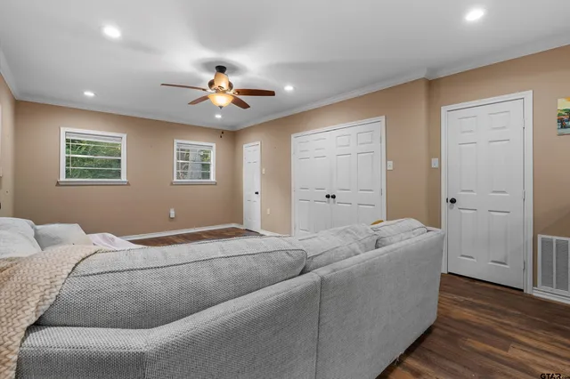 a living room with furniture and a ceiling fan