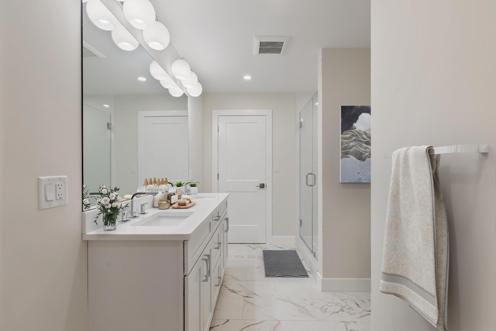 4 Adams Street Wakefield, MA 01880 - Photo 17 of 41 a bathroom with a sink mirror and a shower