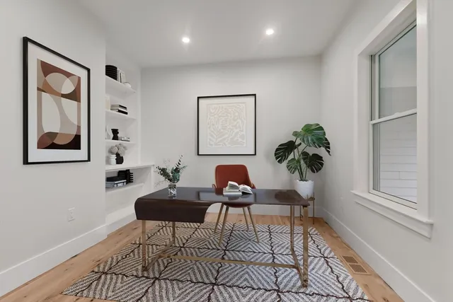 a spacious bathroom with a granite countertop toilet a sink and a mirror