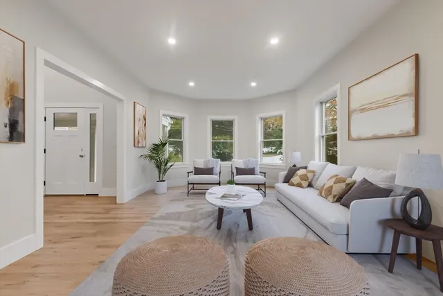 a living room with furniture a lamp and a window