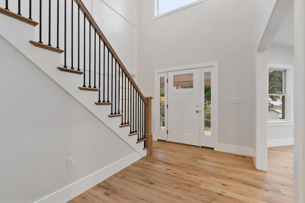 4 Adams Street Wakefield, MA 01880 - Photo 9 of 41 a view of staircase with wooden floor and white walls