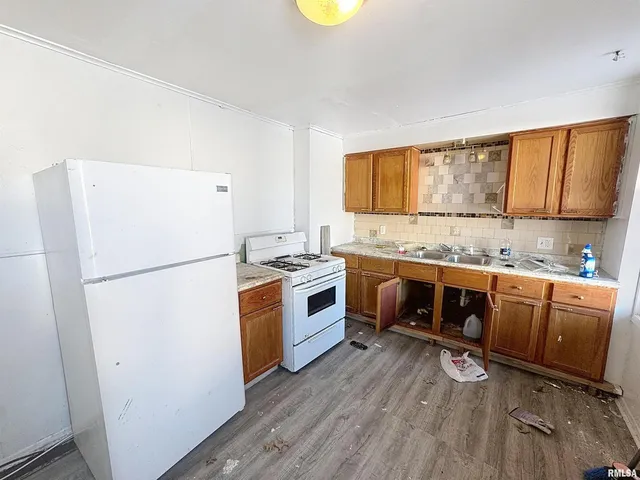 a kitchen with stainless steel appliances a stove a refrigerator and a refrigerator