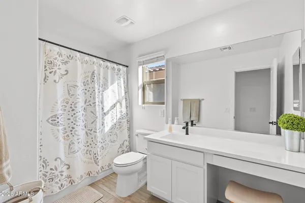 a bathroom with a sink toilet and shower