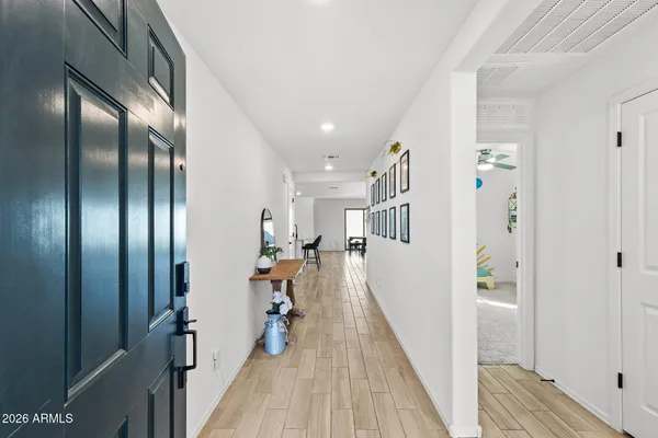 a view of a hallway with wooden floor and stairs