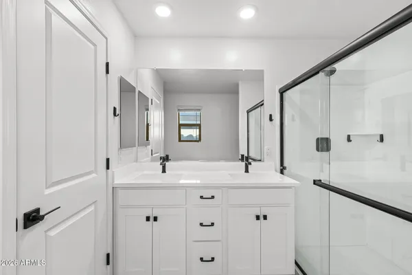 a bathroom with a double vanity sink mirror and double