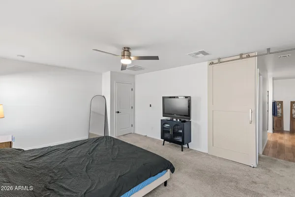 a bedroom with a bed and a chandelier