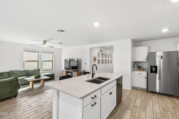 a kitchen with refrigerator cabinets and wooden floor