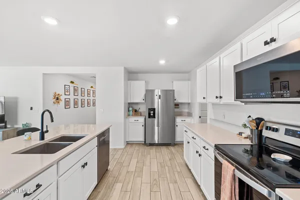 a kitchen with a sink stove and cabinets