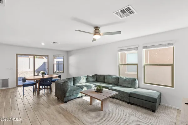 a living room with furniture and wooden floor