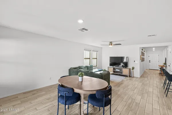 a view of a dining room with furniture and wooden floor