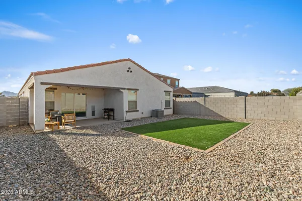 a front view of a house with a garden and yard