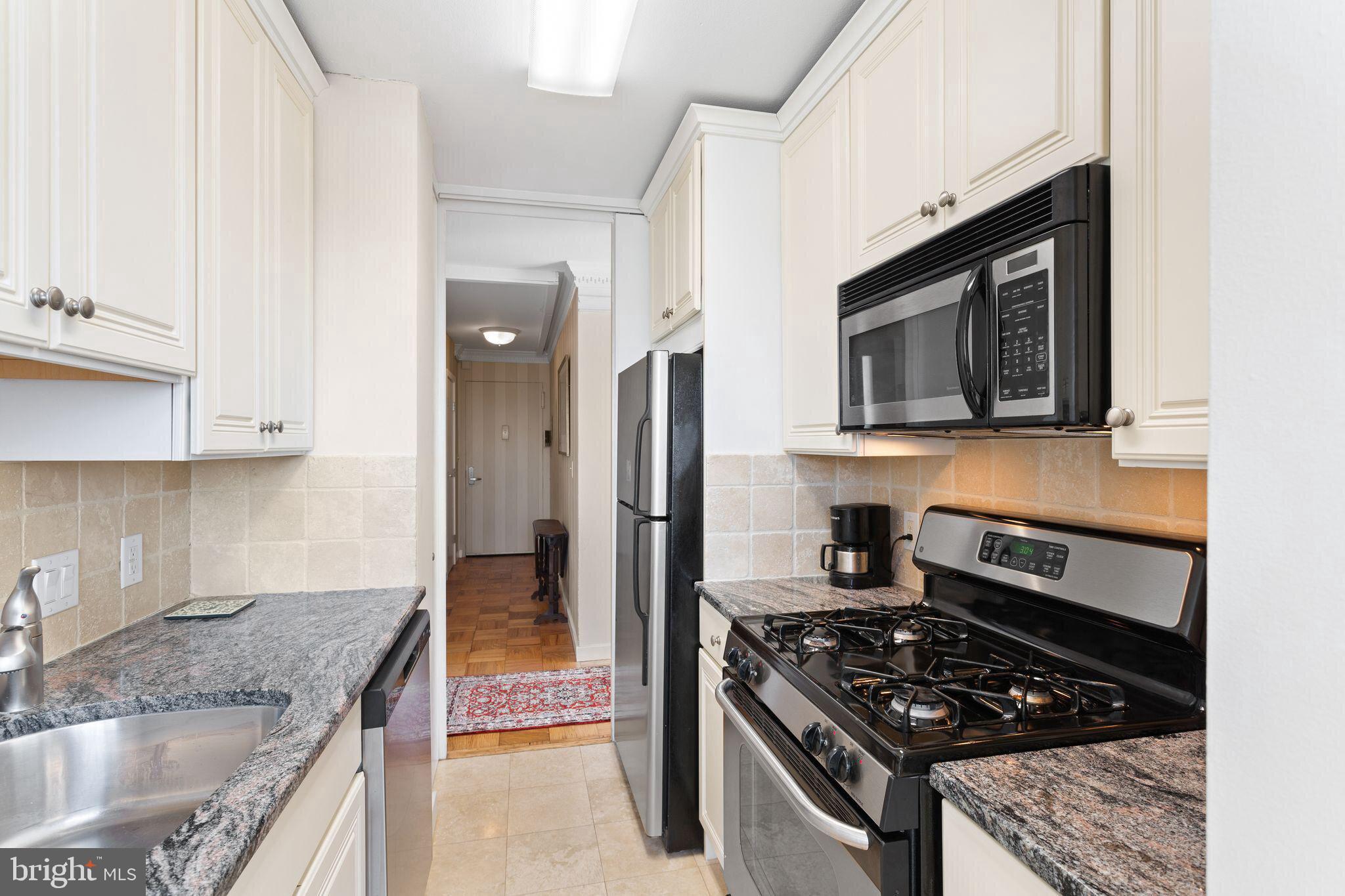 200 Locust Street, Unit 29AN Philadelphia, PA 19106 - Photo 16 of 58 a kitchen with stainless steel appliances granite countertop a stove microwave and sink