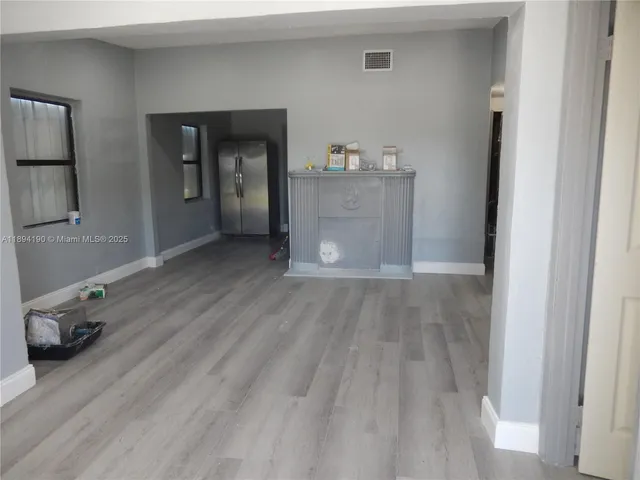 a view of livingroom with kitchen and hardwood