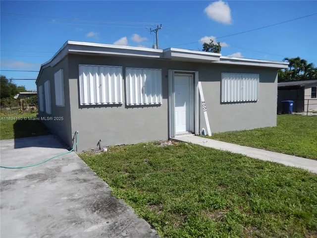 a view of a kitchen with wooden floor and cabinets