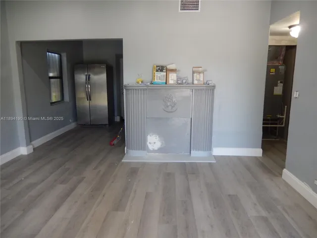 a view of room with window and wooden floor