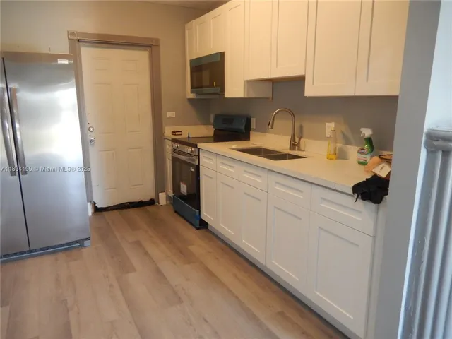 a kitchen with a refrigerator and a sink