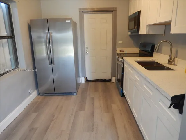 a view of hallway with wooden floor