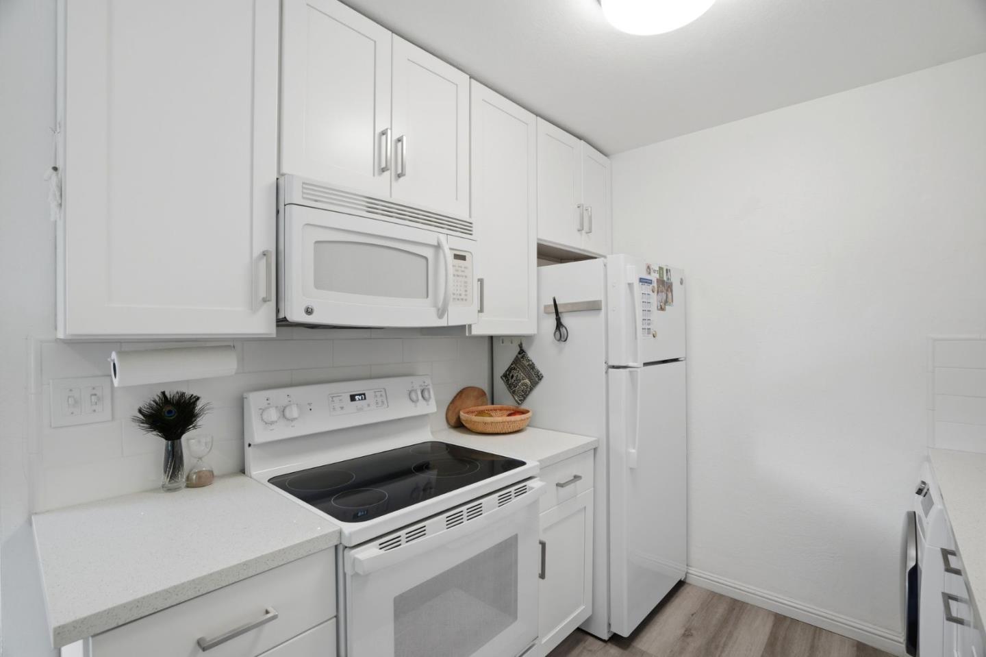 2025 California Street, Unit 40 Mountain View, CA 94040 - Photo 14 of 31 a kitchen with stainless steel appliances granite countertop white cabinets and a stove
