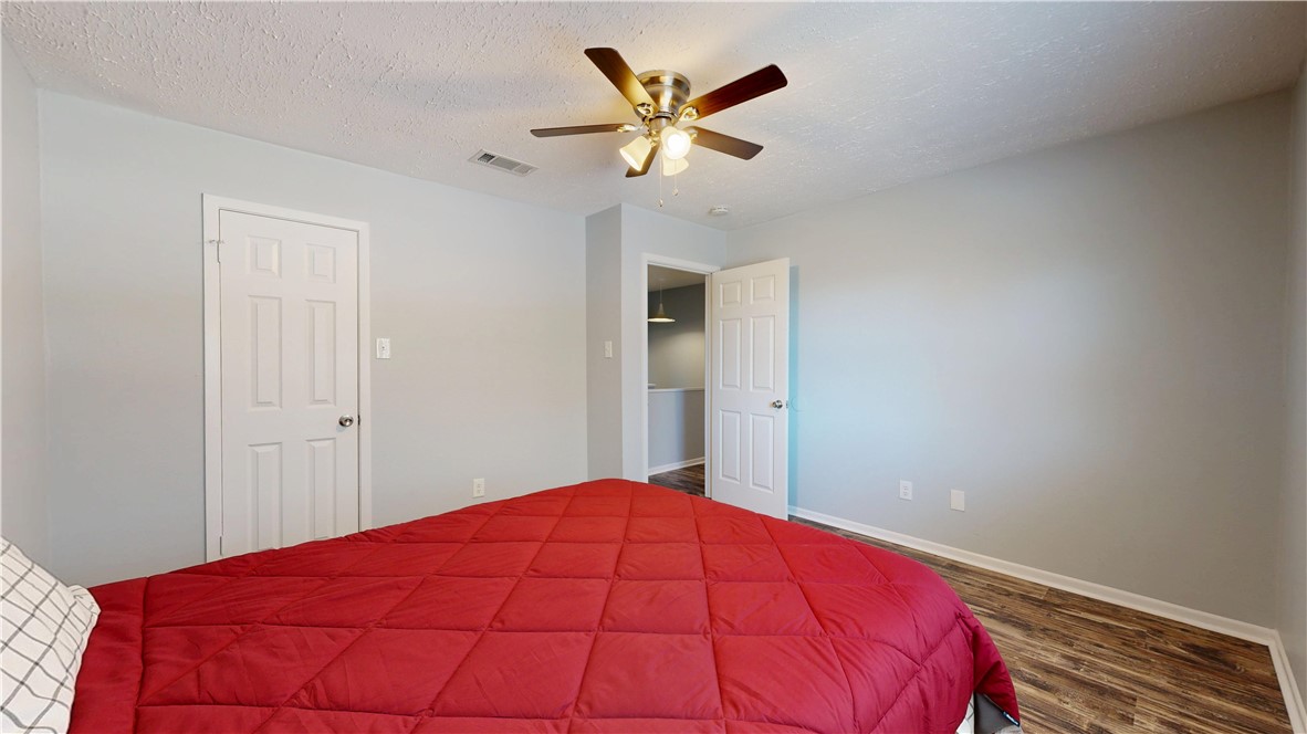 1325 Airline Drive College Station, TX 77845 - Photo 16 of 26 a view of a bedroom with a ceiling fan and a chandelier fan