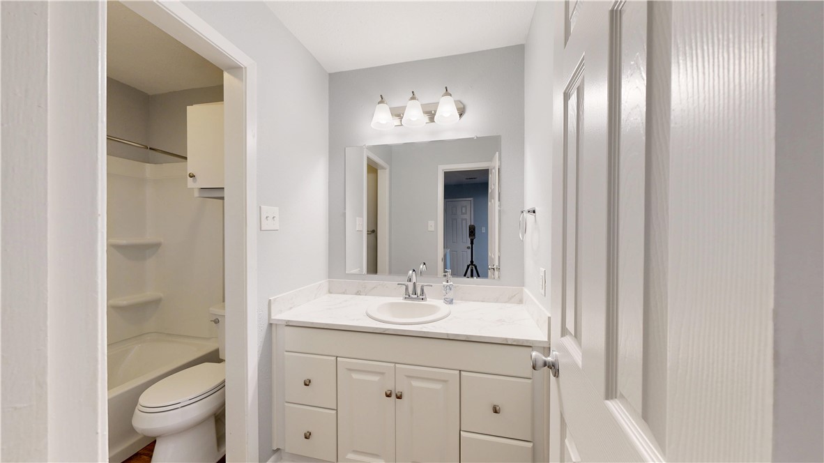 1325 Airline Drive College Station, TX 77845 - Photo 19 of 26 a bathroom with a double vanity sink toilet and shower
