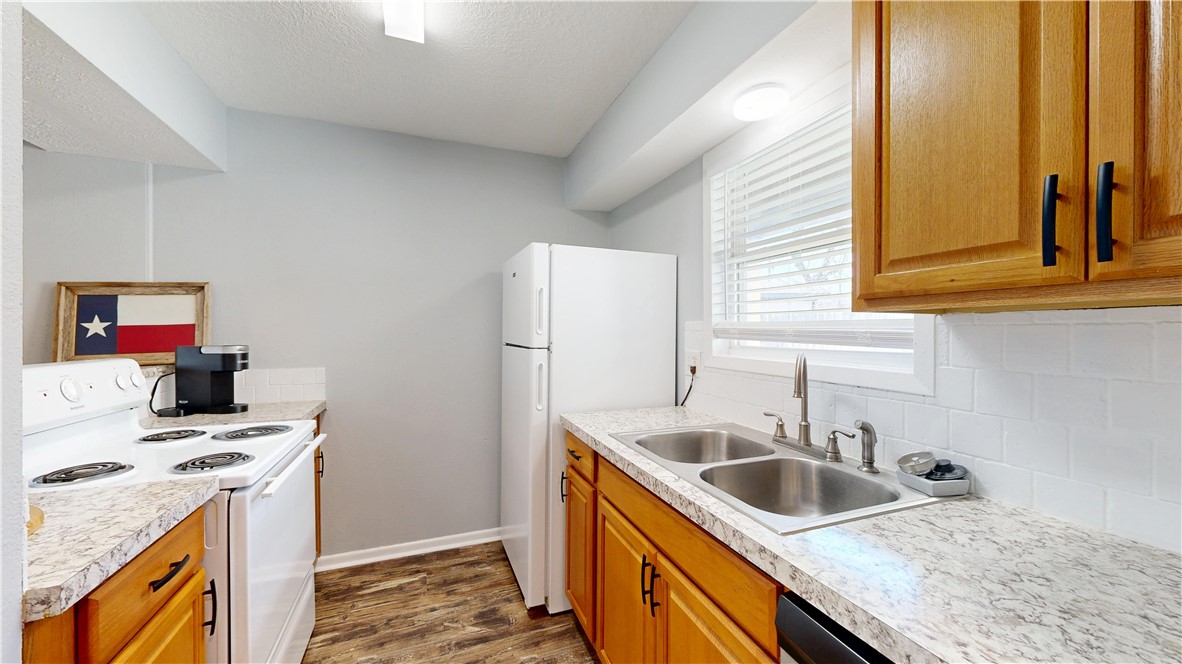 1325 Airline Drive College Station, TX 77845 - Photo 5 of 26 a kitchen that has a sink and a stove