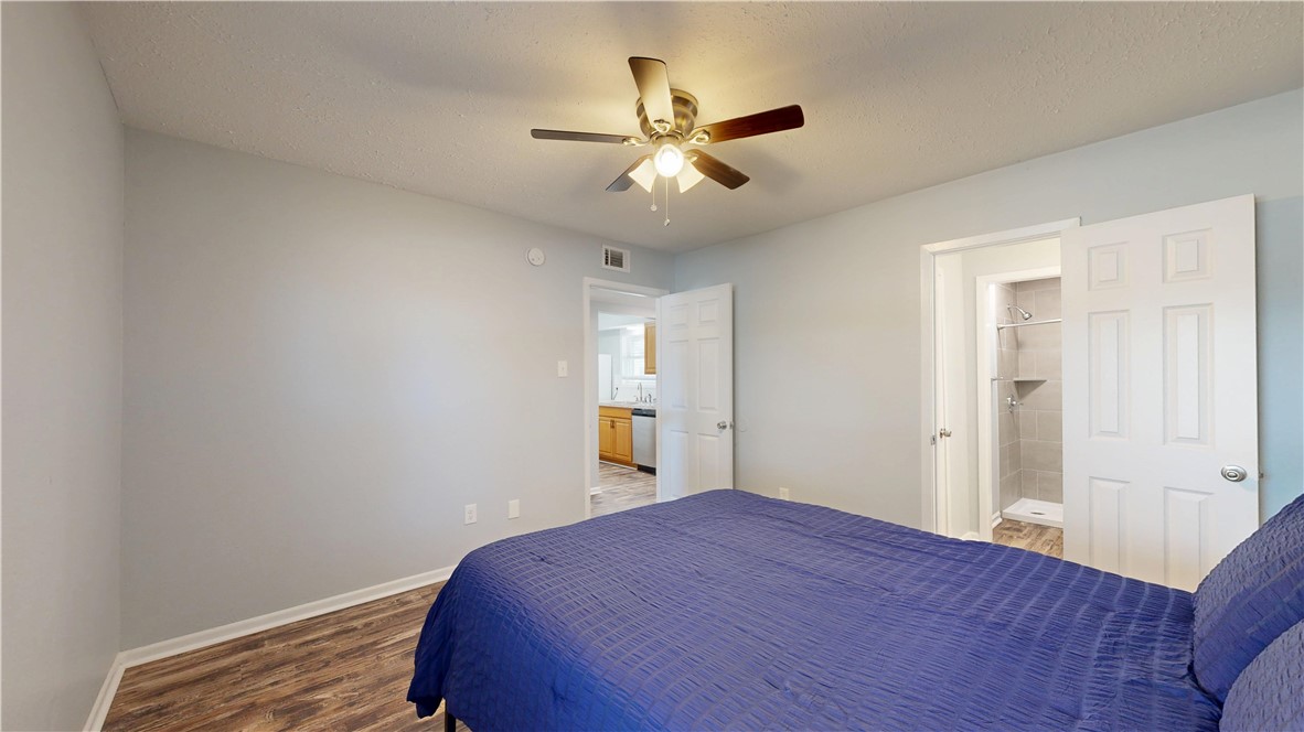 1325 Airline Drive College Station, TX 77845 - Photo 9 of 26 a bedroom with a bed and a chandelier