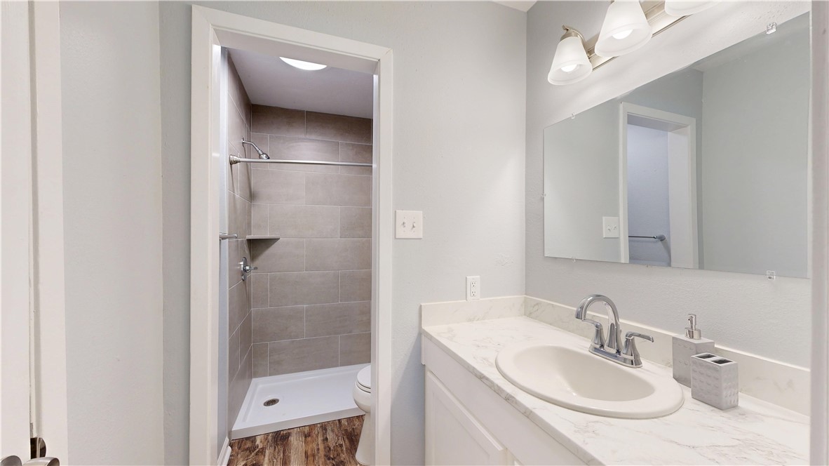 1325 Airline Drive College Station, TX 77845 - Photo 10 of 26 a bathroom with a sink a toilet a shower and a mirror