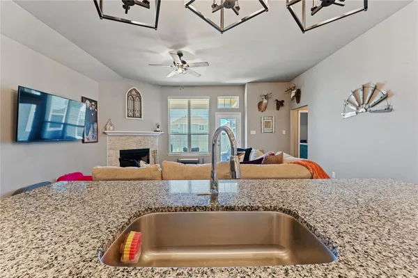 a kitchen view of a sink and chandelier
