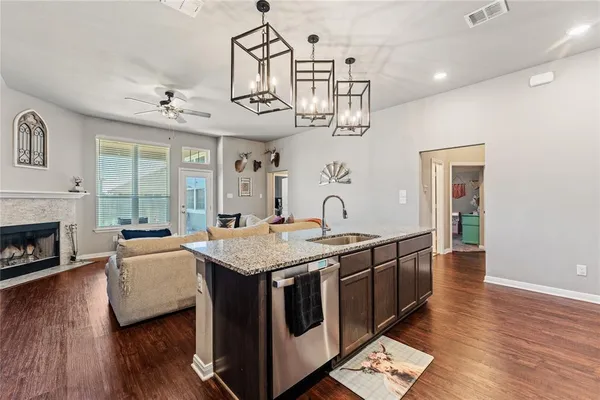 a kitchen with stainless steel appliances granite countertop a sink and stove