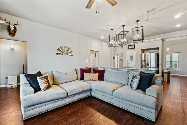 a living room with furniture and kitchen view